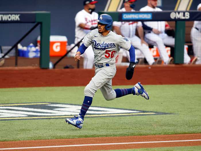 Oct 14, 2020; Arlington, Texas, USA; Los Angeles Dodgers right fielder Mookie Betts (50) scores on a hit by shortstop Corey Seager against the Atlanta Braves during the first inning of game three of the 2020 NLCS at Globe Life Field.